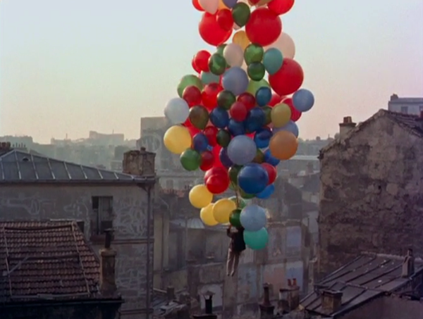 boy and balloons above Paris